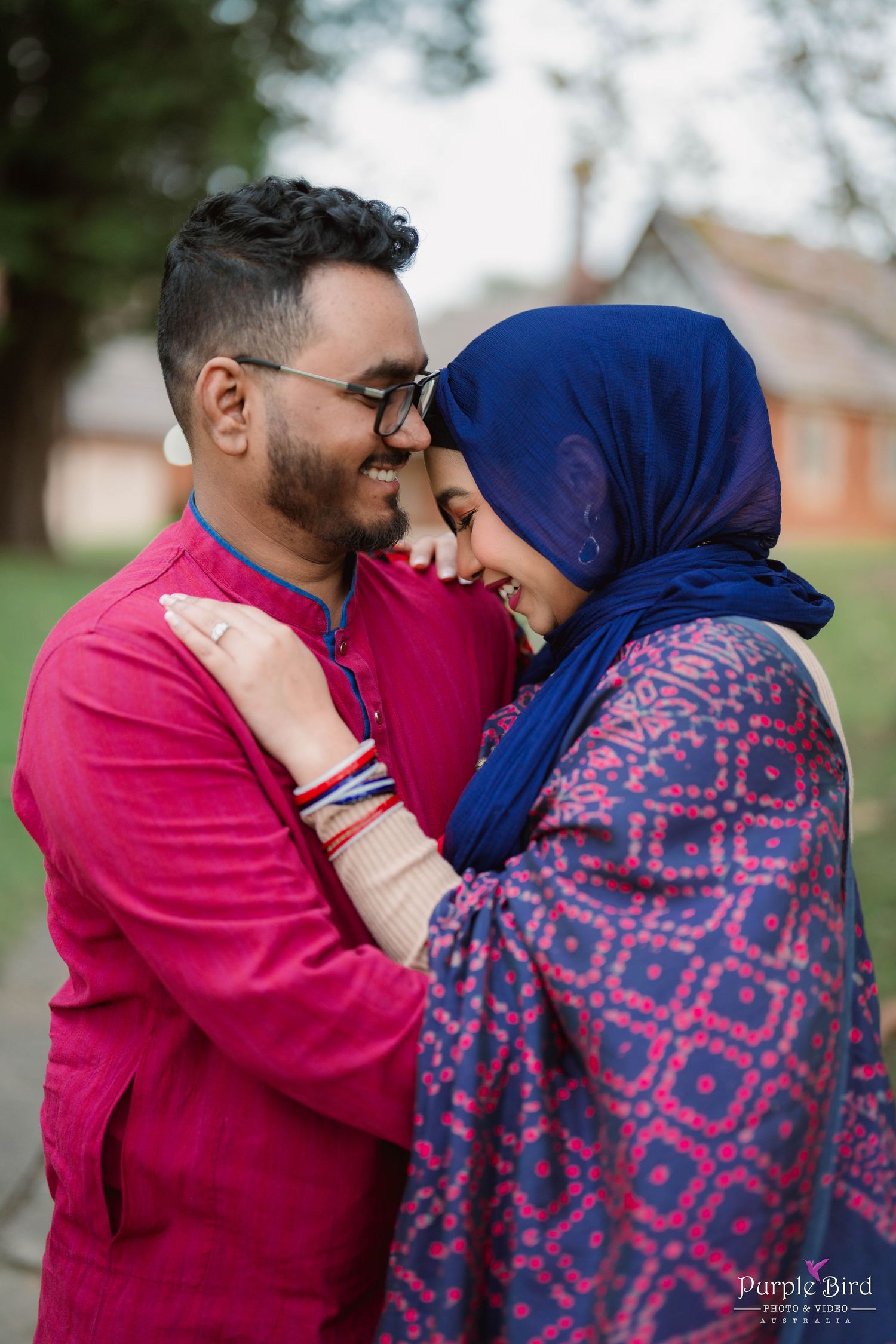 A couple in matching red and blue outfits share tender moments together in a romantic outdoor photoshoot sequence.