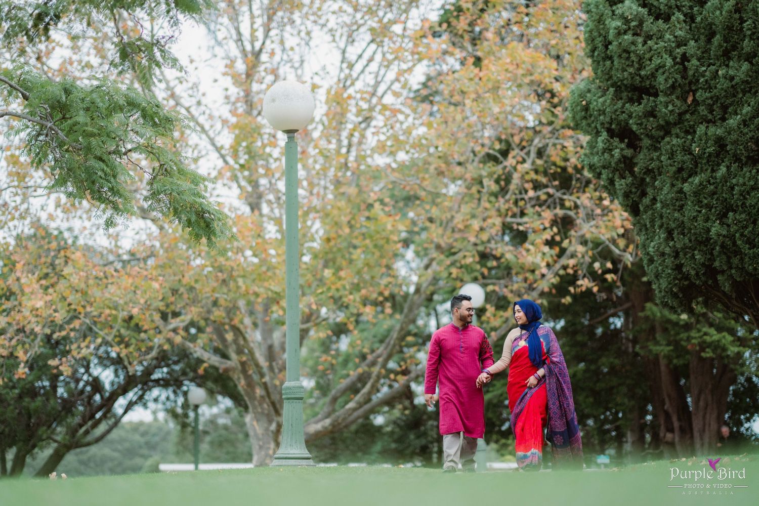 Outdoor engagement photography session with trees and greenery creating a natural backdrop in the park.