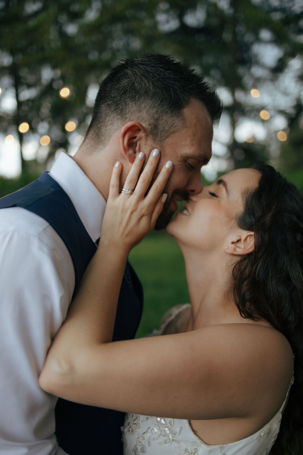 Romantic sequence of wedding couple sharing passionate kisses outdoors with soft lighting and natural background.