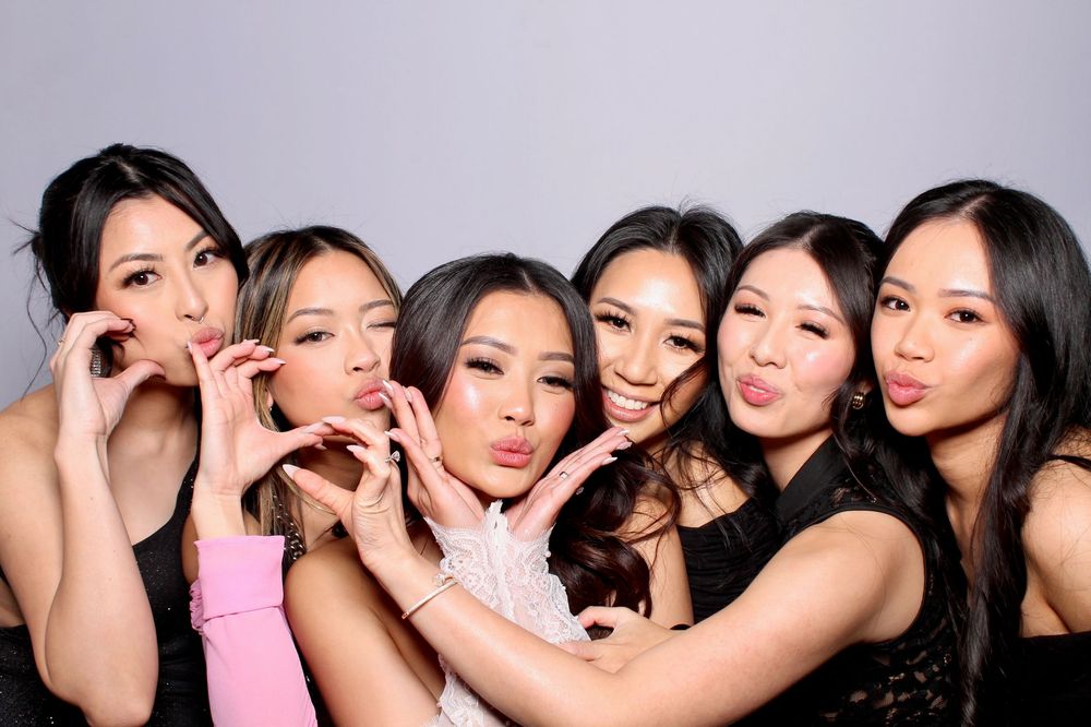 A group of six friends having fun and making silly faces together in a photo booth style portrait.