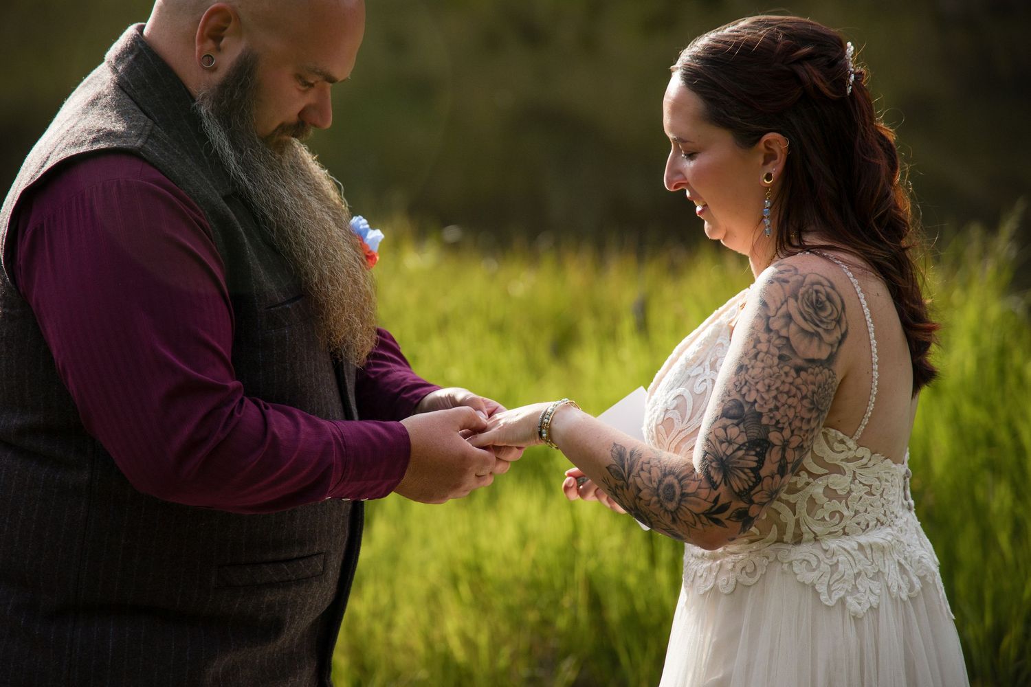 A couple shares a romantic moment in a sunlit field during their wedding photo session.