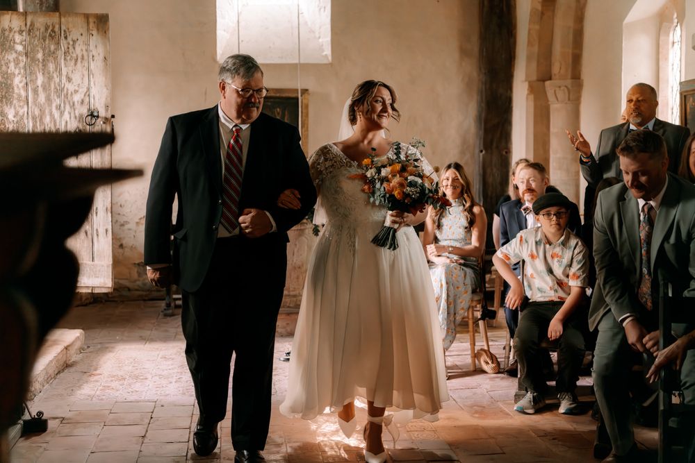 A series of wedding venue photos showing guests gathering in an ornate hallway with stone columns and arches.