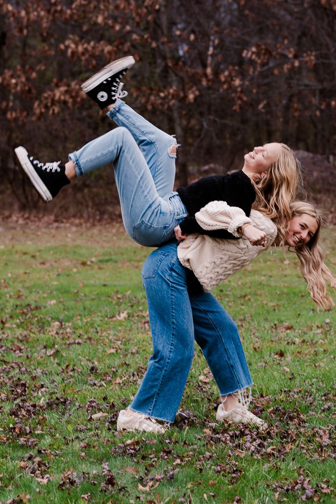 Playful sequence showing person in jeans doing cartwheels on autumn grass.