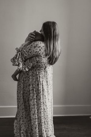 A series of black and white photographs showing a person in a floral dress turning away from the camera.