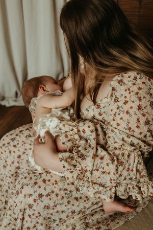 A series of intimate close-up shots showing tender moments in a floral dress against a light background.