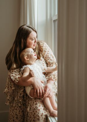 A sequence of nurturing moments captured by a window, featuring soft natural light and floral patterns.