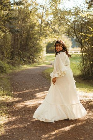 A series of photos showing a white dress flowing gracefully along a sunlit autumn forest path.