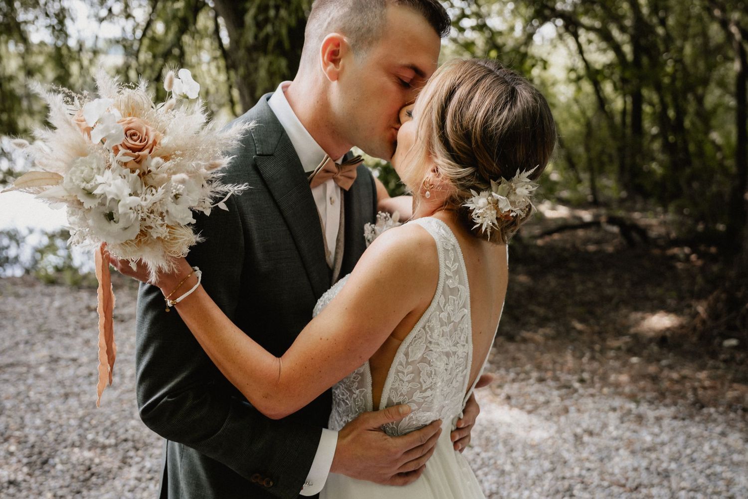 Couple share intimate moments captured in a romantic forest photo session on their wedding day.