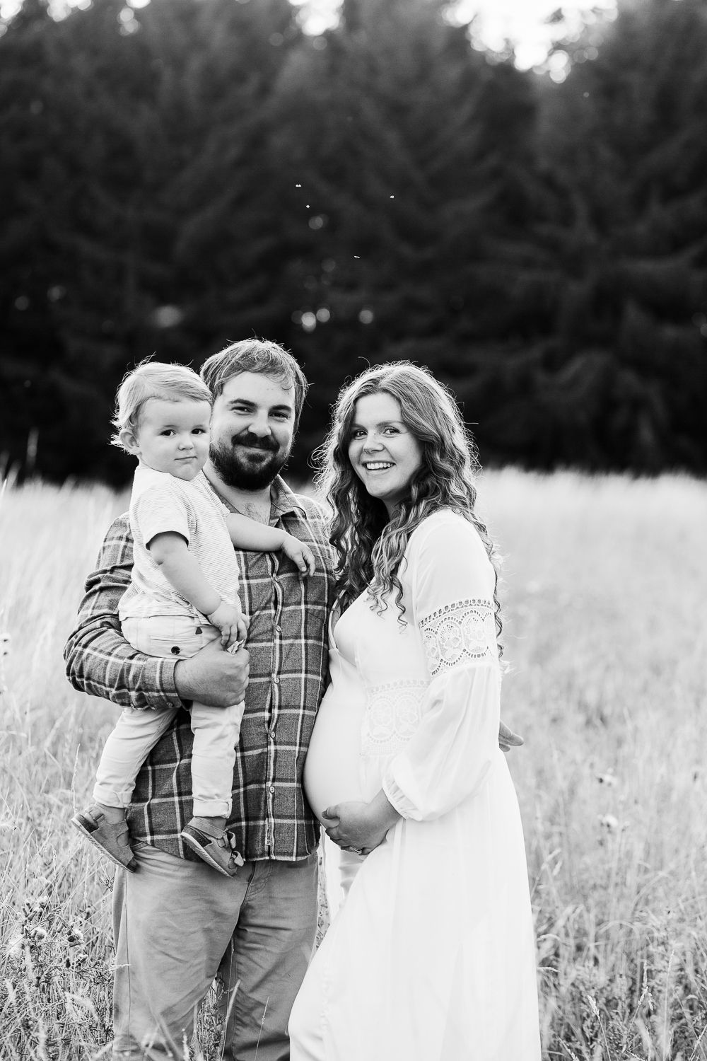 Natural light family photography session showing candid interactions in a meadow.