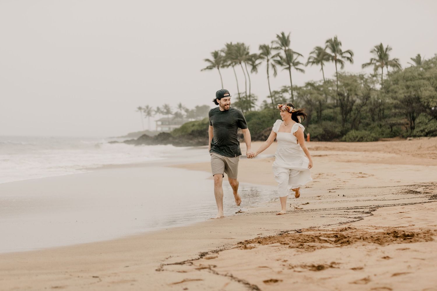 A romantic photoshoot sequence at the beach shows tender embraces between a couple in white and brown outfits.
