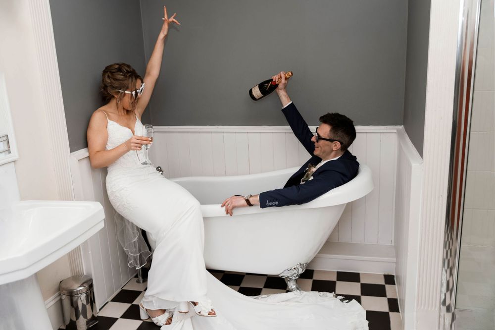 Fun and creative wedding photography in bathtub in Trudder lodge, Wicklow.