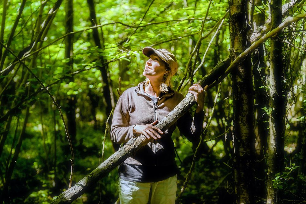 A portrait for the Suffolk Wildlife Trust - Woodland Well-being project of a woman resting in woodland, Suffolk