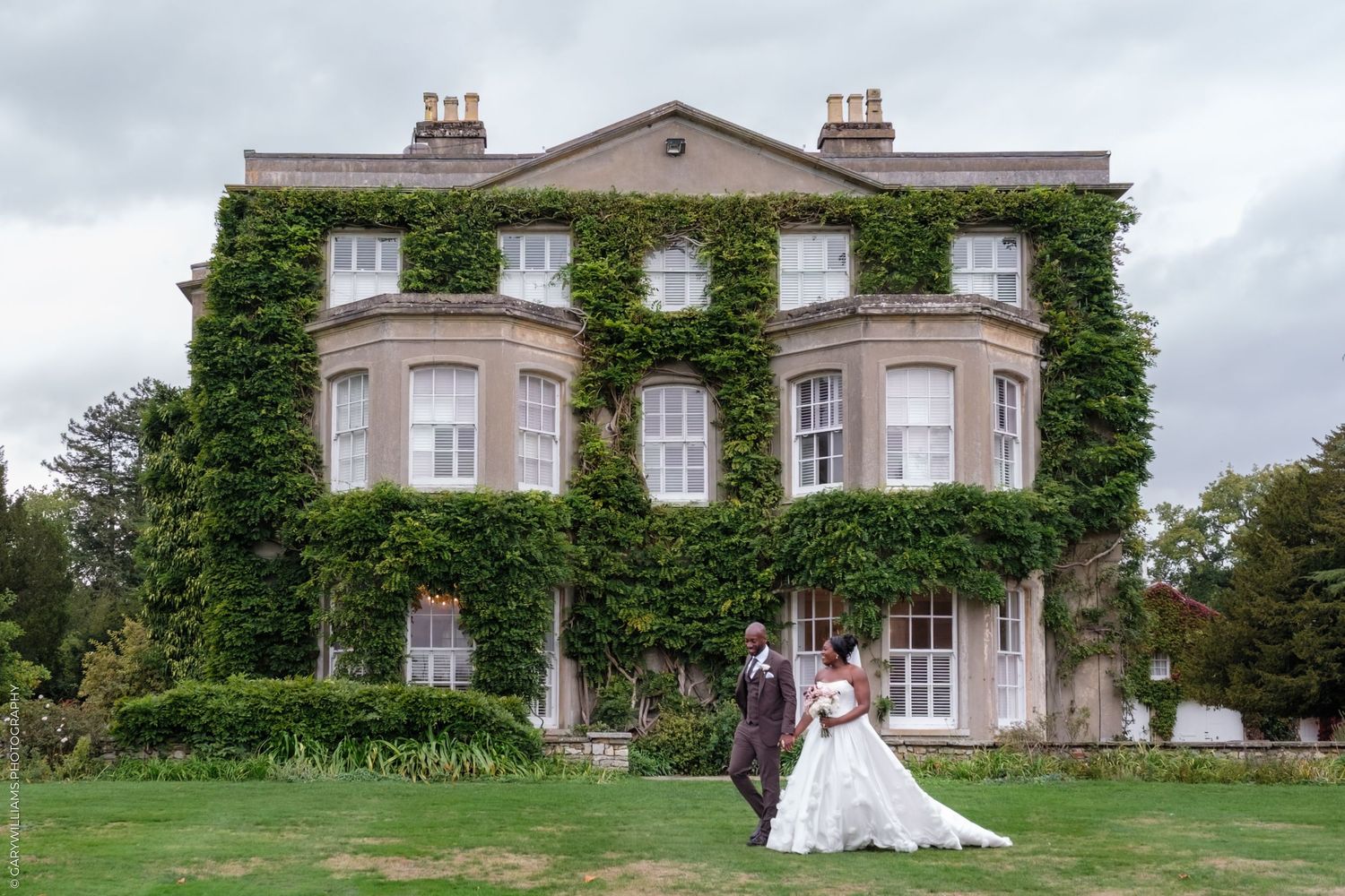 Elegant wedding venue with multiple views of a grand country house covered in ivy and surrounded by manicured gardens.