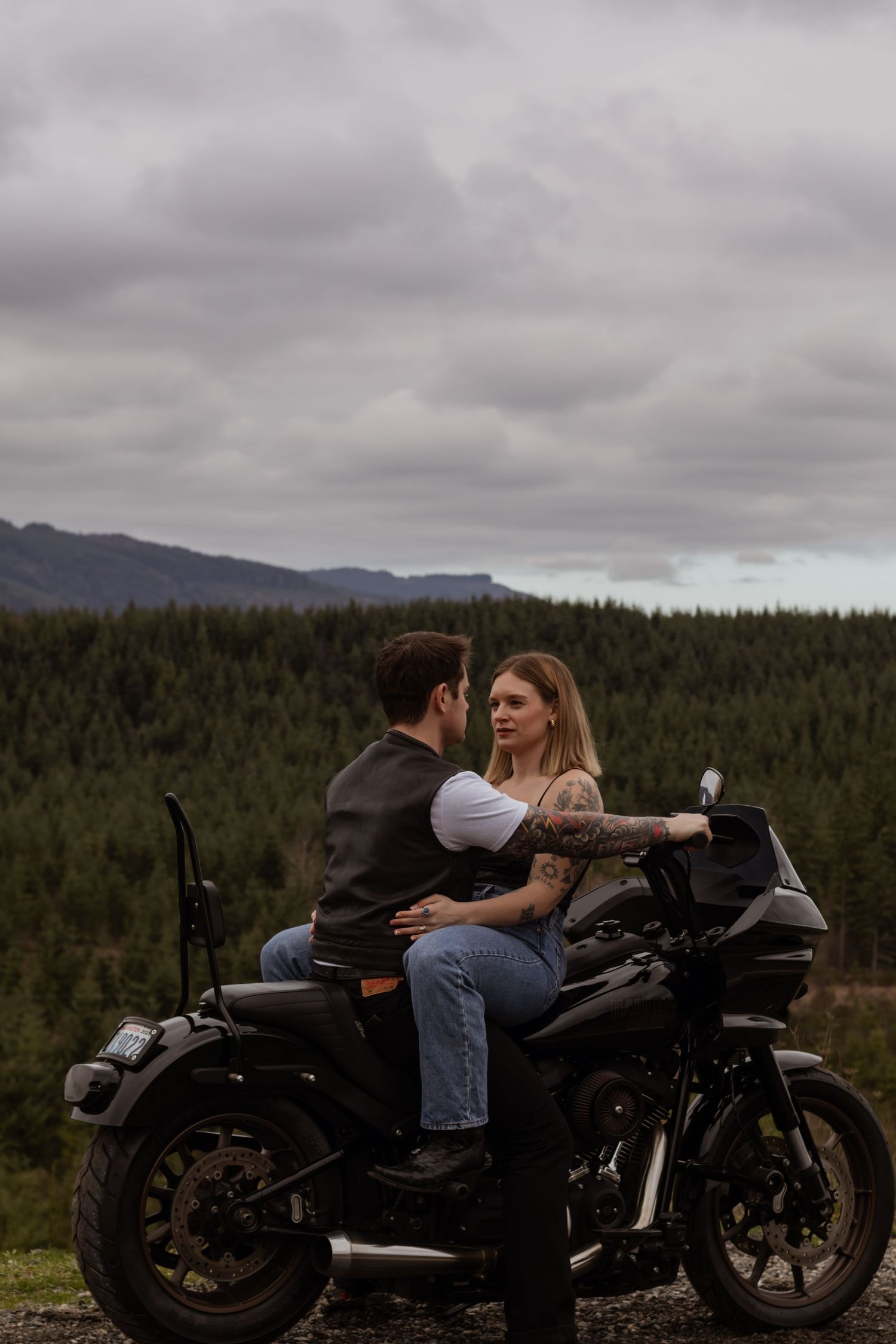 couple in yelm washington hills captured by pierce county photographer on a black harley davidson motorcycle