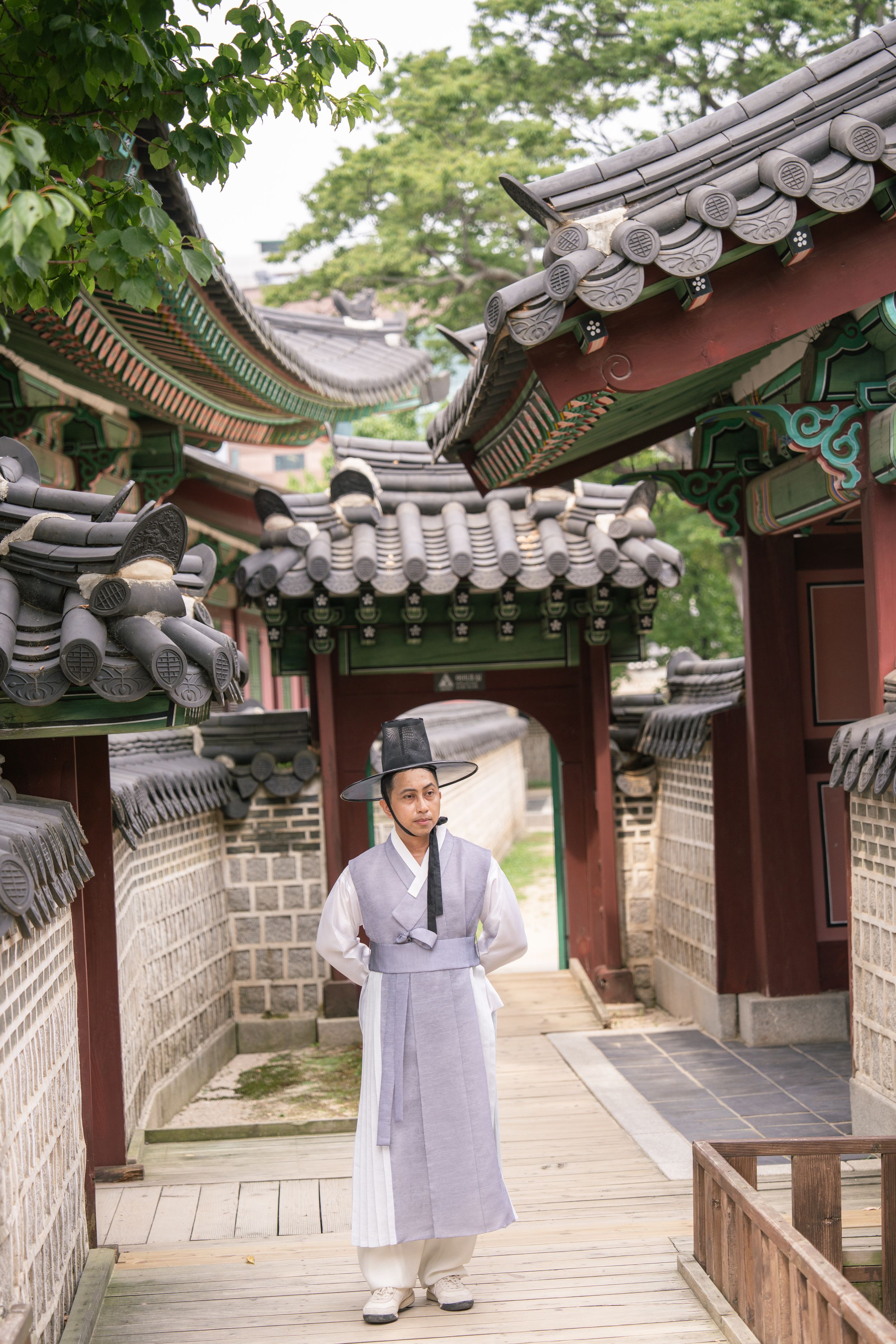 Wooden walkways and traditional architecture at a Korean palace complex.