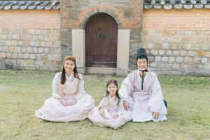 Traditional Korean palace architecture with stone walls and wooden doorways.