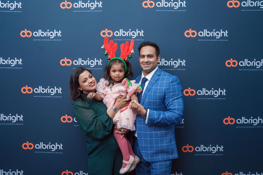 Corporate backdrop wall with albright logo repeat pattern at professional event.