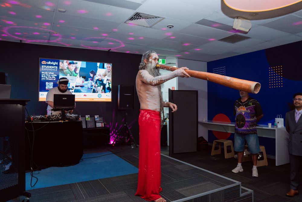 Colorful disco lights illuminate a dark room with multiple screens and entertainment equipment setup.
