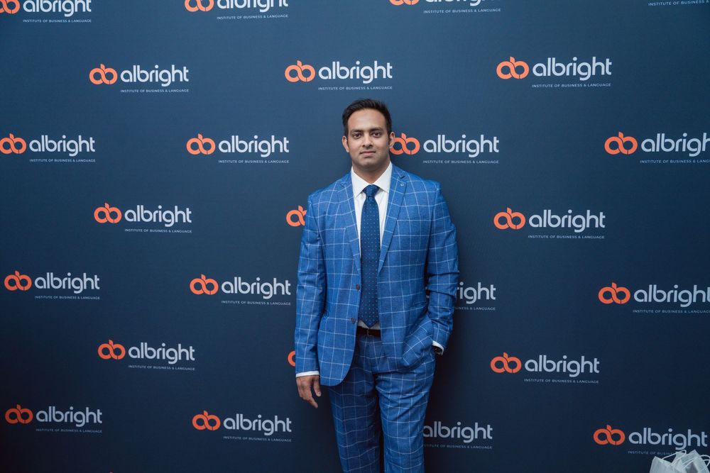 Professional event space with branded backdrop showing albright company logos.