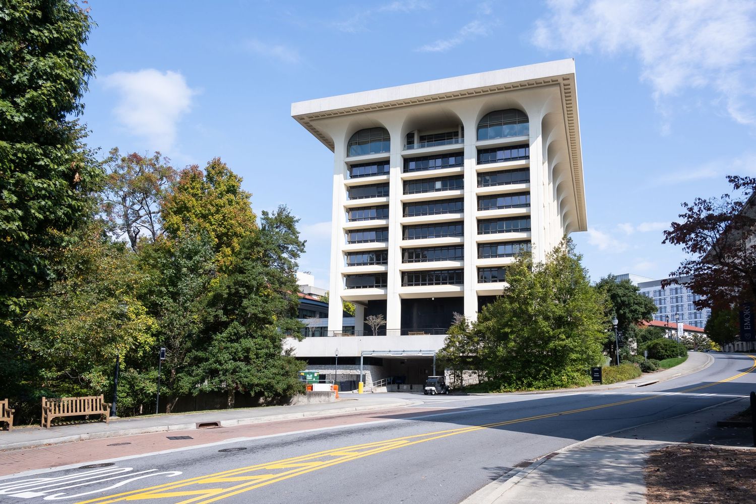Modern office building with arched windows and minimalist architecture design.