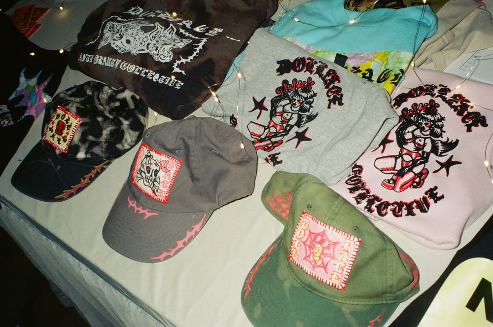 Multiple t-shirts or garments laid out on a surface showing printed designs and patterns.