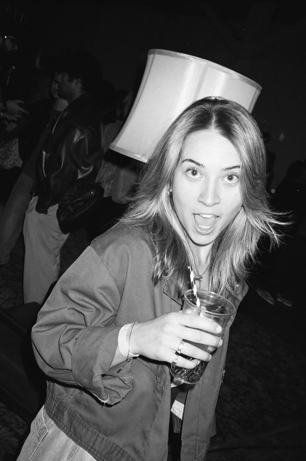 Black and white party photos show someone enjoying drinks in a casual setting.