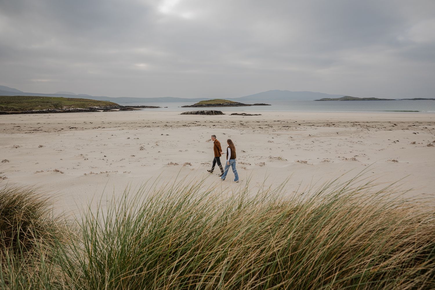 couple walking on silver strand beach during adventure couple session