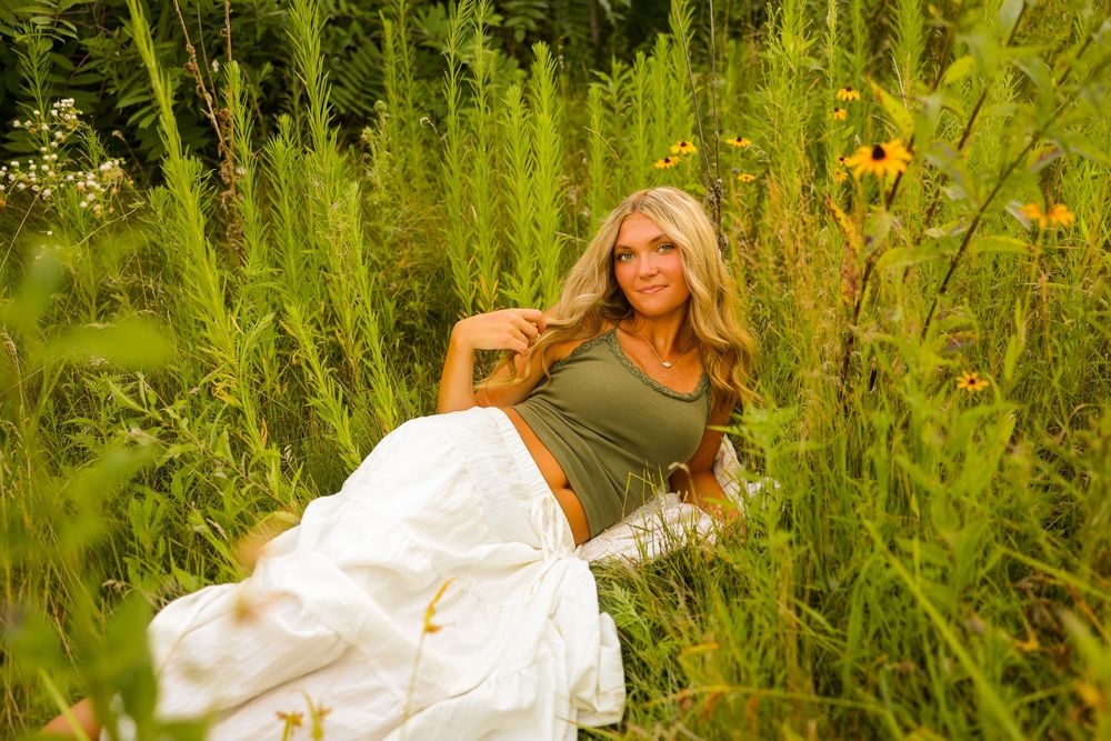Stillwater, MN senior photographer girl laying in a flower field.