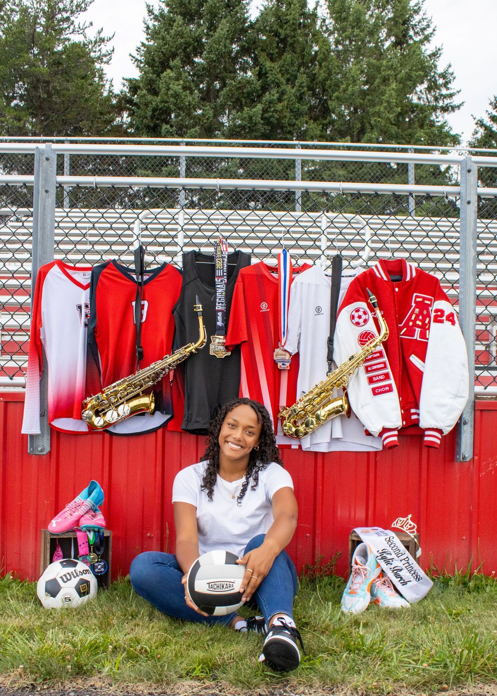 Senior photo session with jerseys, instrument, princess tiara, and soccer ball to showcase all her high school talents in Amery, Wisconsin.