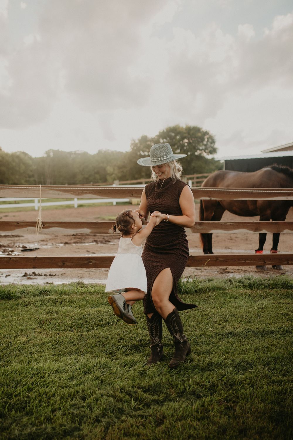 A series of candid shots at a farm showing movement and play near a horse paddock with wooden fencing at sunset.