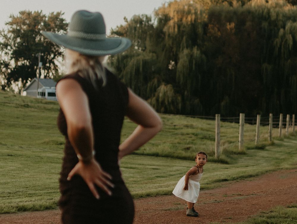 A series of athletic motion photos showing someone performing a cartwheel on a dirt path in a grassy outdoor setting.