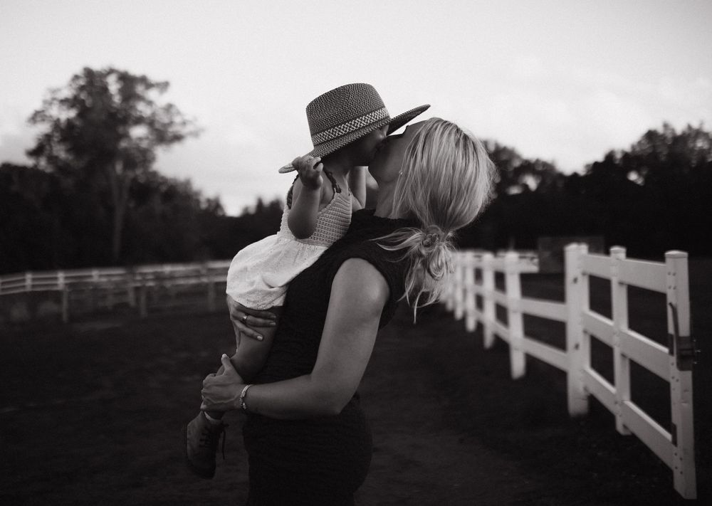 A couple sharing an intimate moment while holding champagne glasses in a rustic venue.