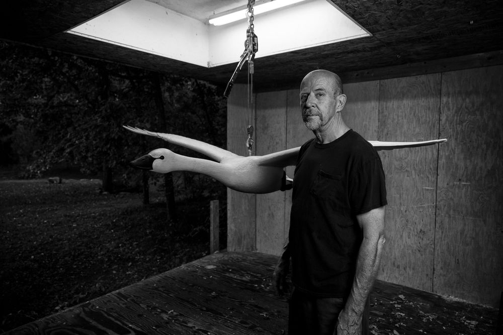 Black and white image of a person demonstrating a sequence of dance movements in an indoor studio space.