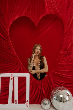 Disco-themed photo series with silver mirror balls against a dramatic red fabric backdrop creating a retro party atmosphere.