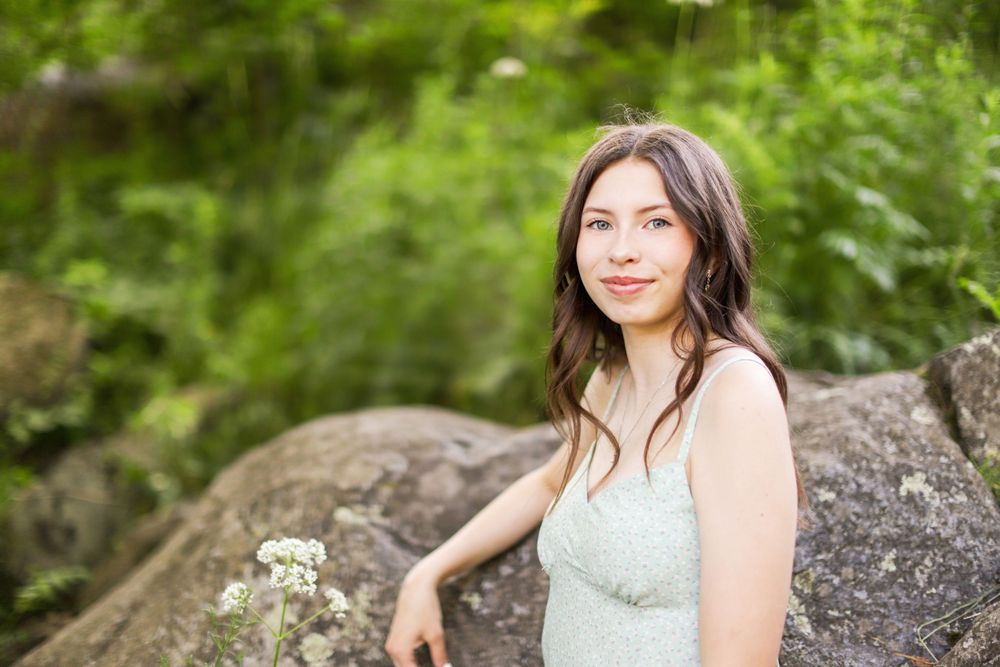 High school senior standing near stone walls at Enger Tower Park in Duluth