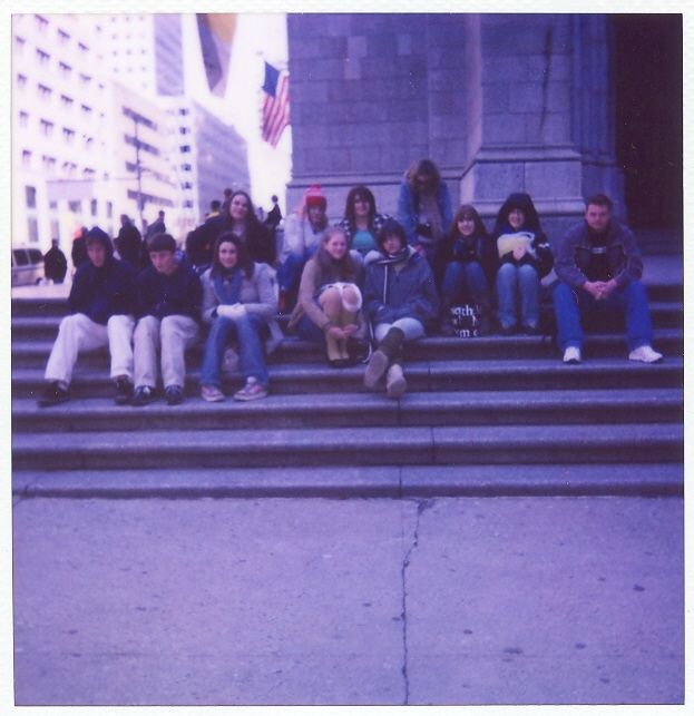Jessica photographing her high school art club sitting on the steps of a cathedral during a trip to New York City with her Polaroid SX-70.