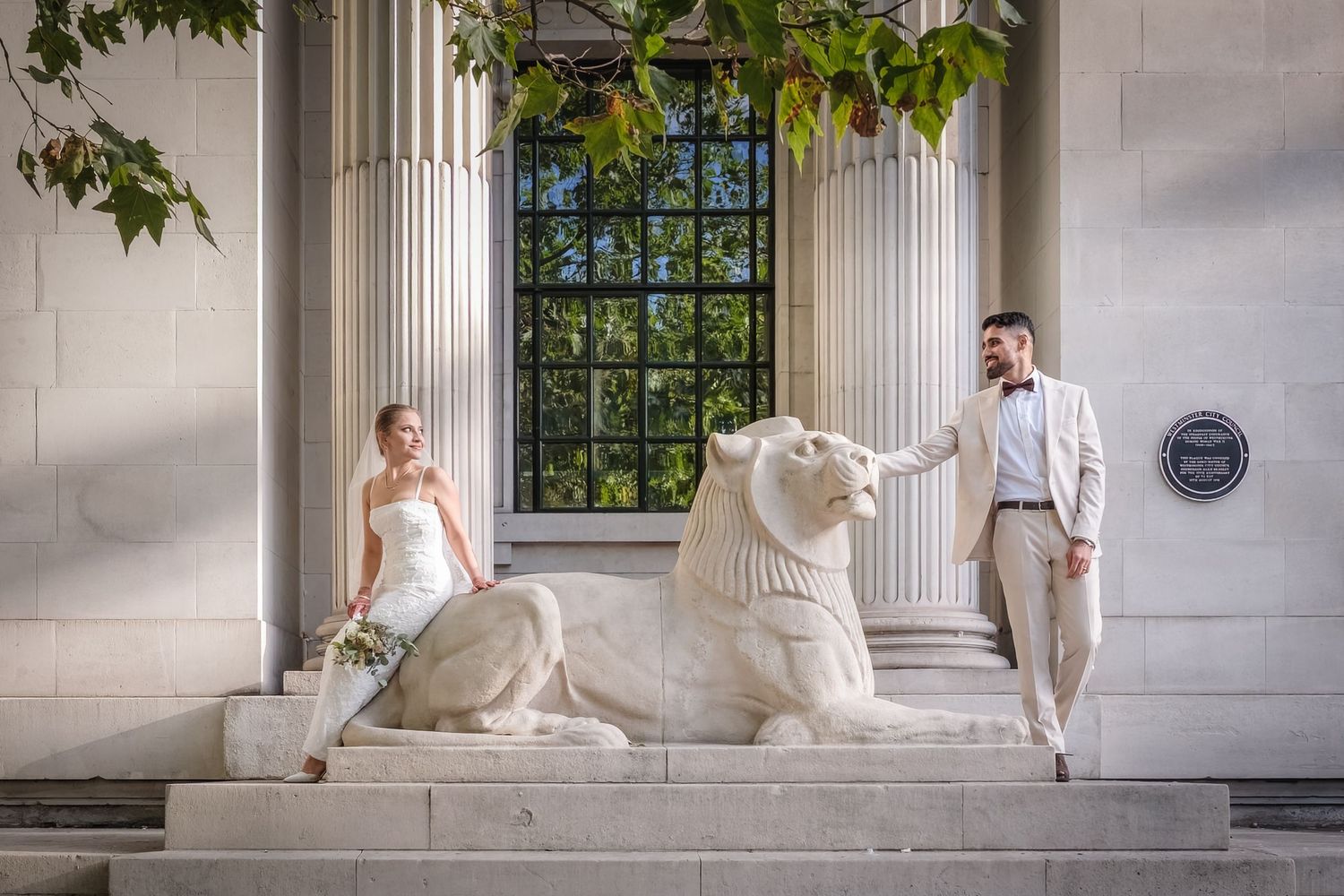 Black and white wedding photos show couple posing on grand stone steps in elegant formal attire after London wedding