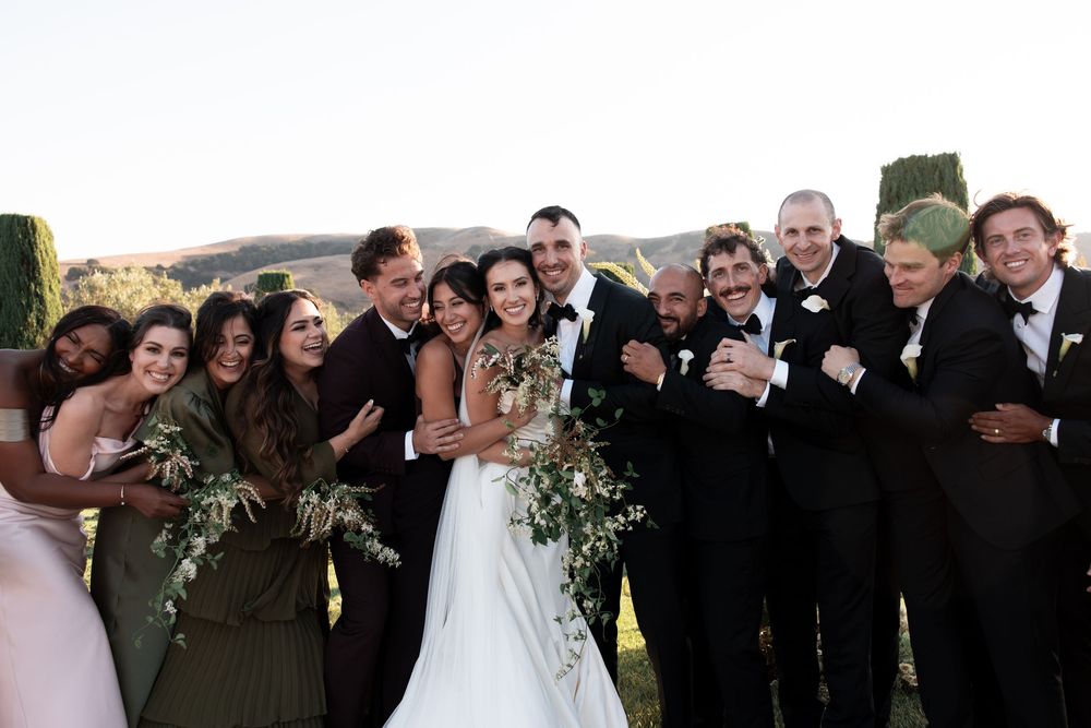 A collage of wedding party photos showing groups posing and celebrating outdoors on a sunny day.