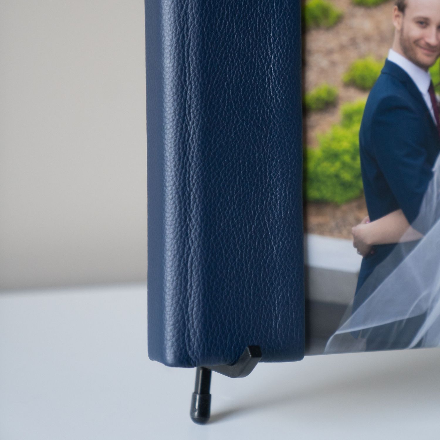 Close-up view of a dark blue leather album cover.