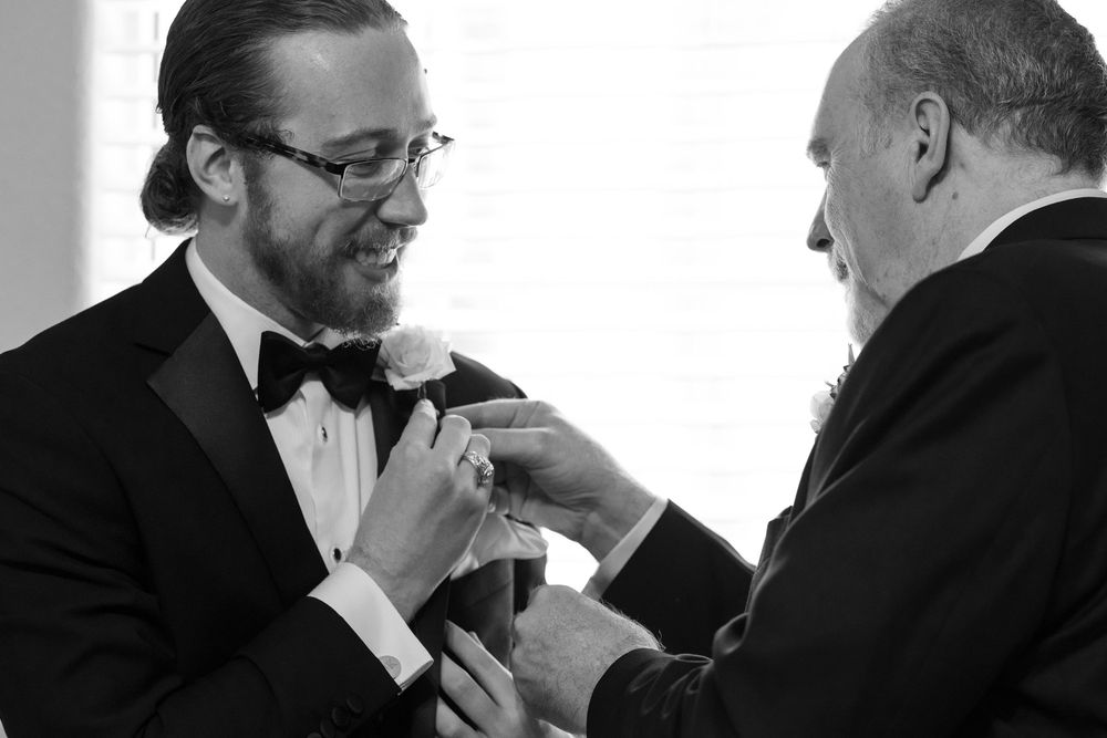 A series of black and white photos showing someone helping adjust a bow tie on another person's formal attire.