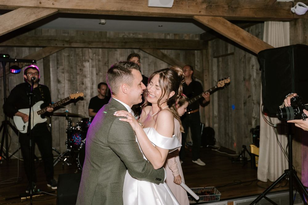 A Worcestershire bride & Groom shares a romantic dance moment at their wedding reception in a rustic barn venue.