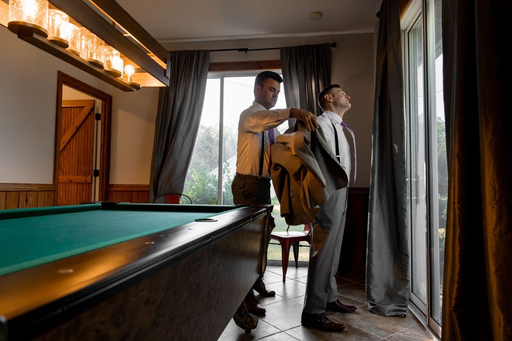A series of connected images showing people playing pool in a dimly lit room with large windows and dark curtains.