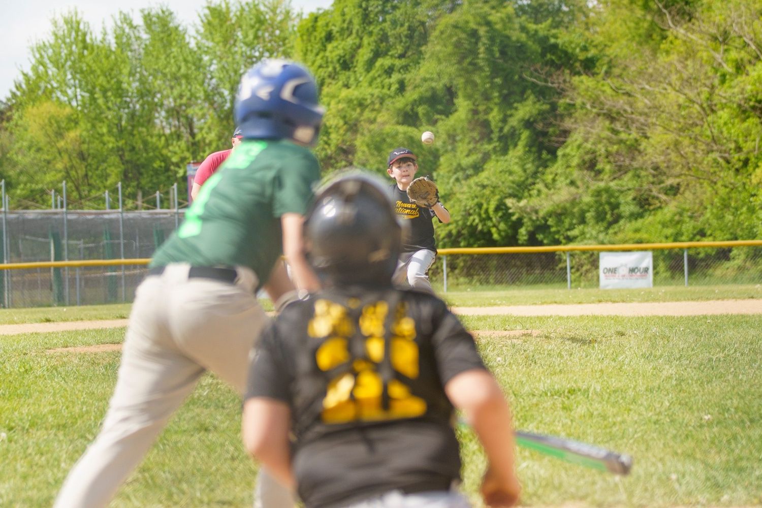 Youth baseball pitcher photographed with the Sony A7iii during live game action