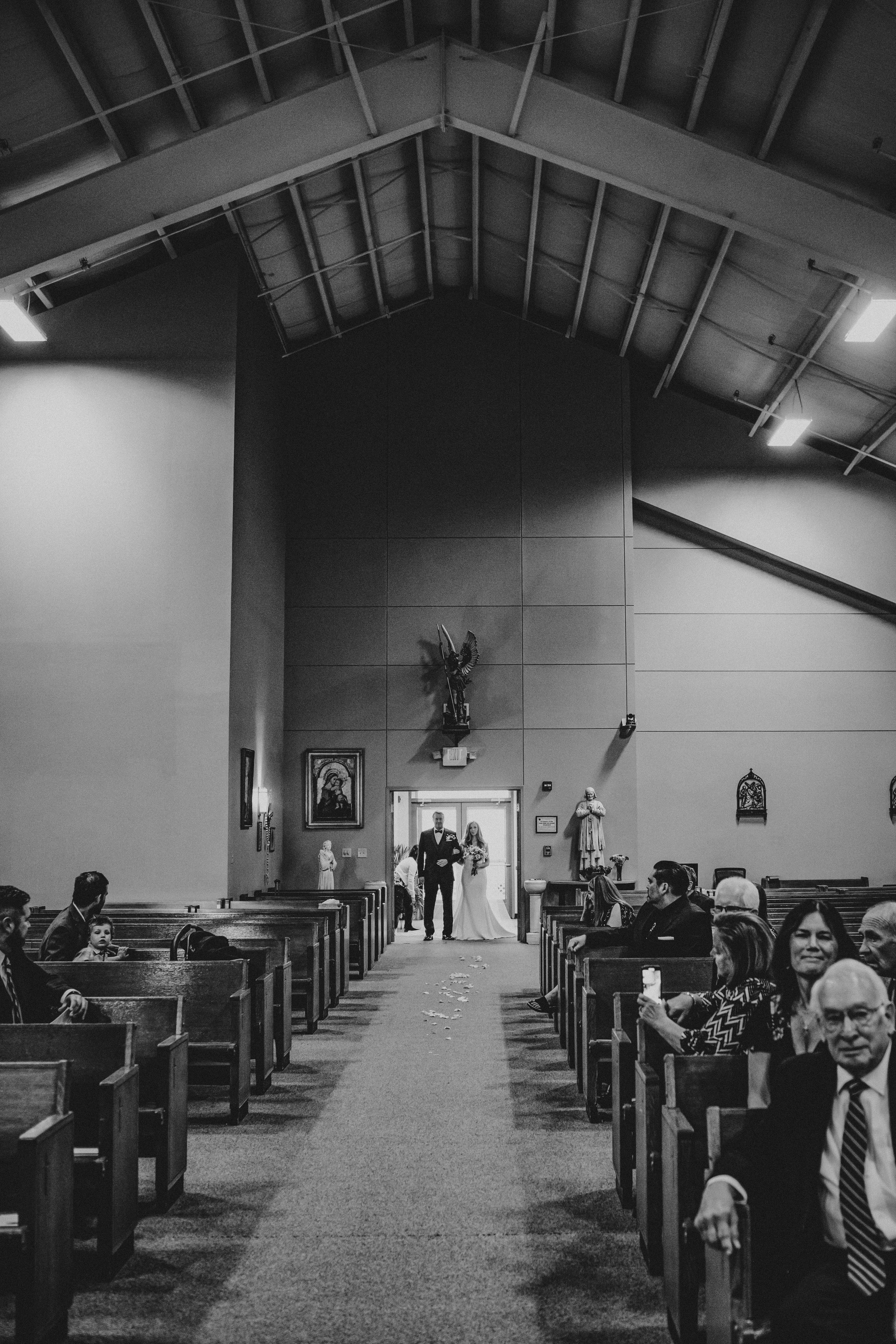 Black and white panoramic sequence showing the interior of a church sanctuary with wooden pews and vaulted ceiling.