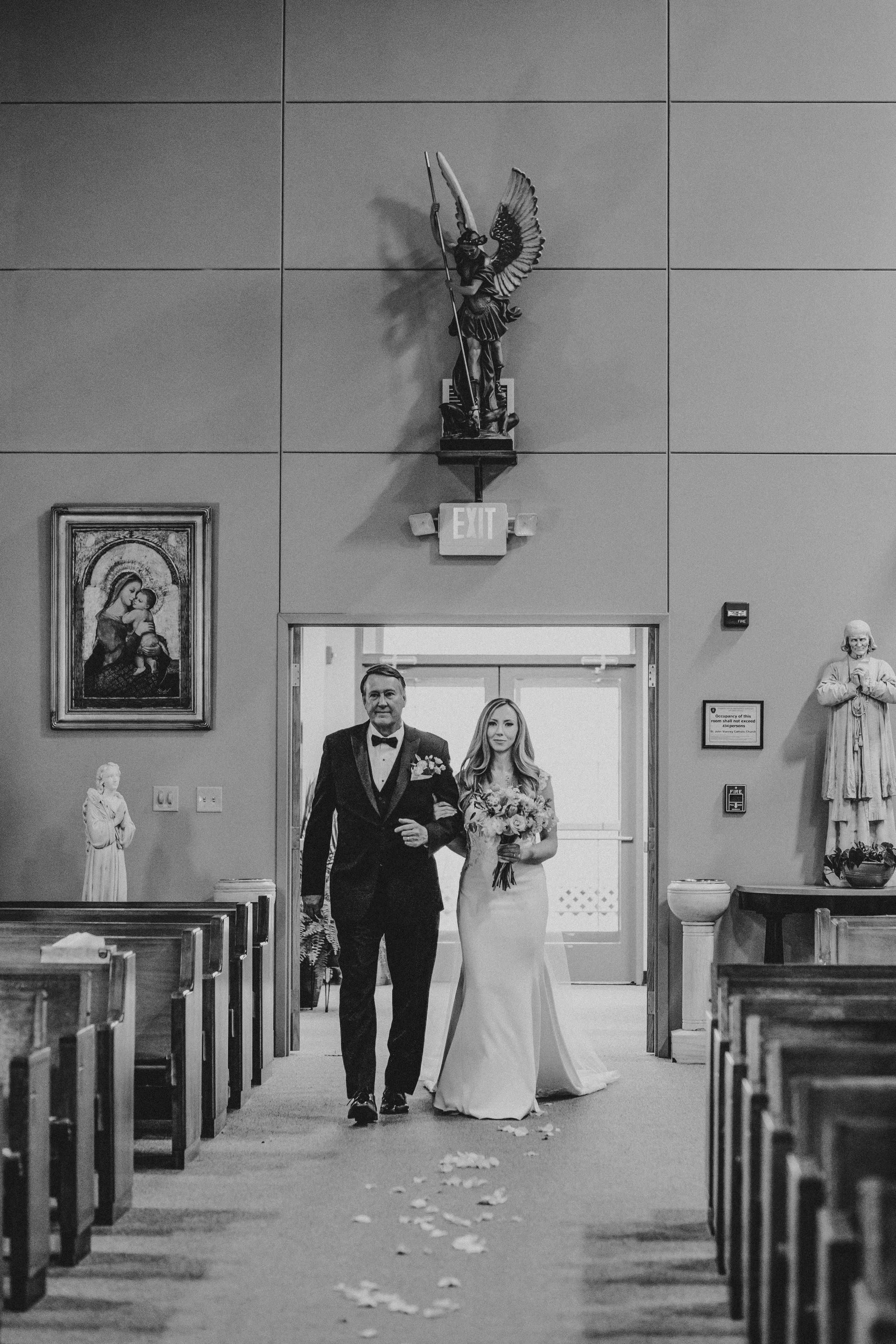 Black and white photo sequence showing a couple walking down a church aisle with flower petals scattered on the ground.