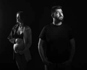 A dramatic black and white photo sequence showing a person in dark clothing against a black background.