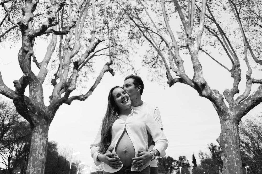 Black and white photo series showing people dancing and having fun under trees in an outdoor setting.
