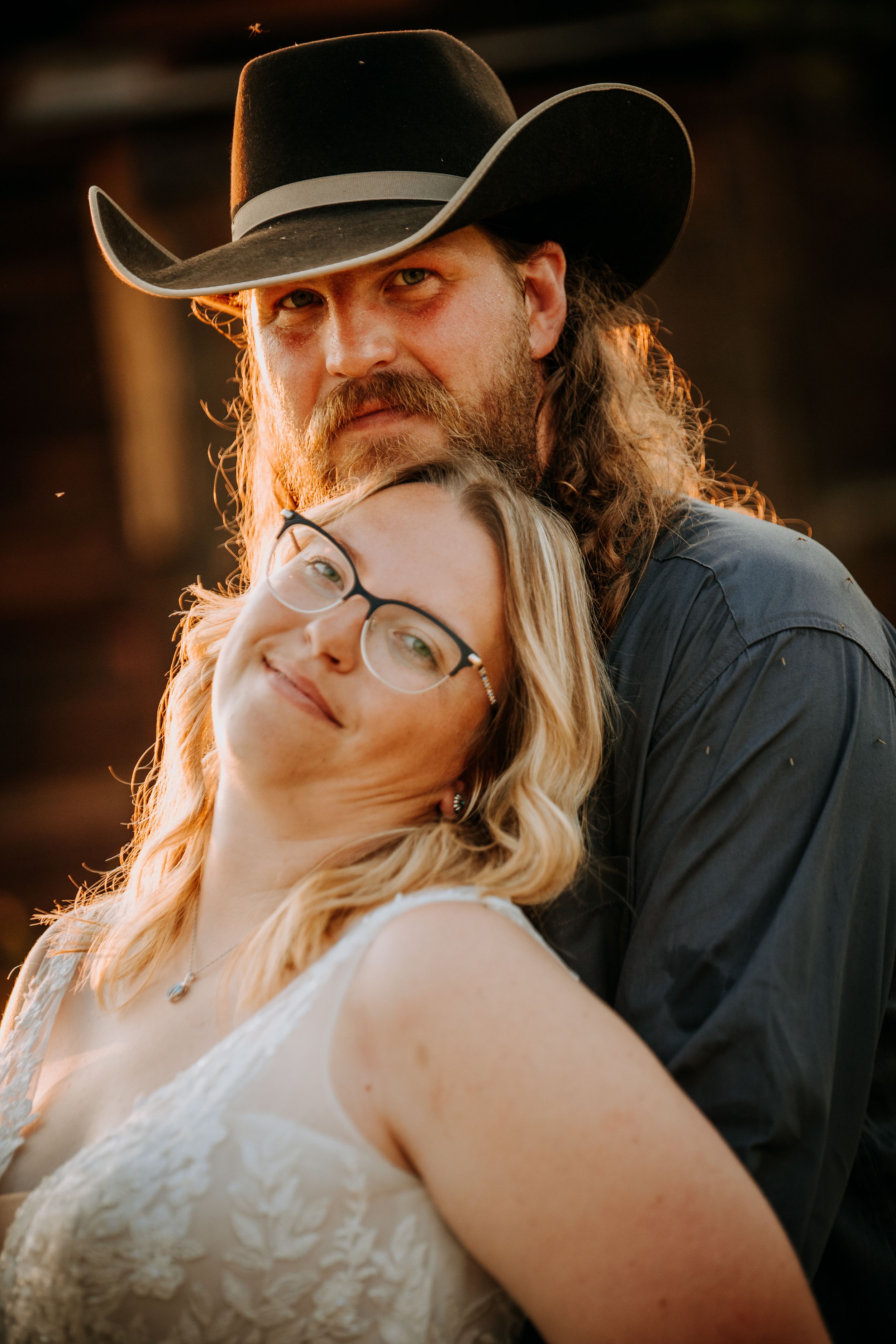 A romantic wedding photo series showing intimate close-up moments between a couple at sunset with warm lighting.