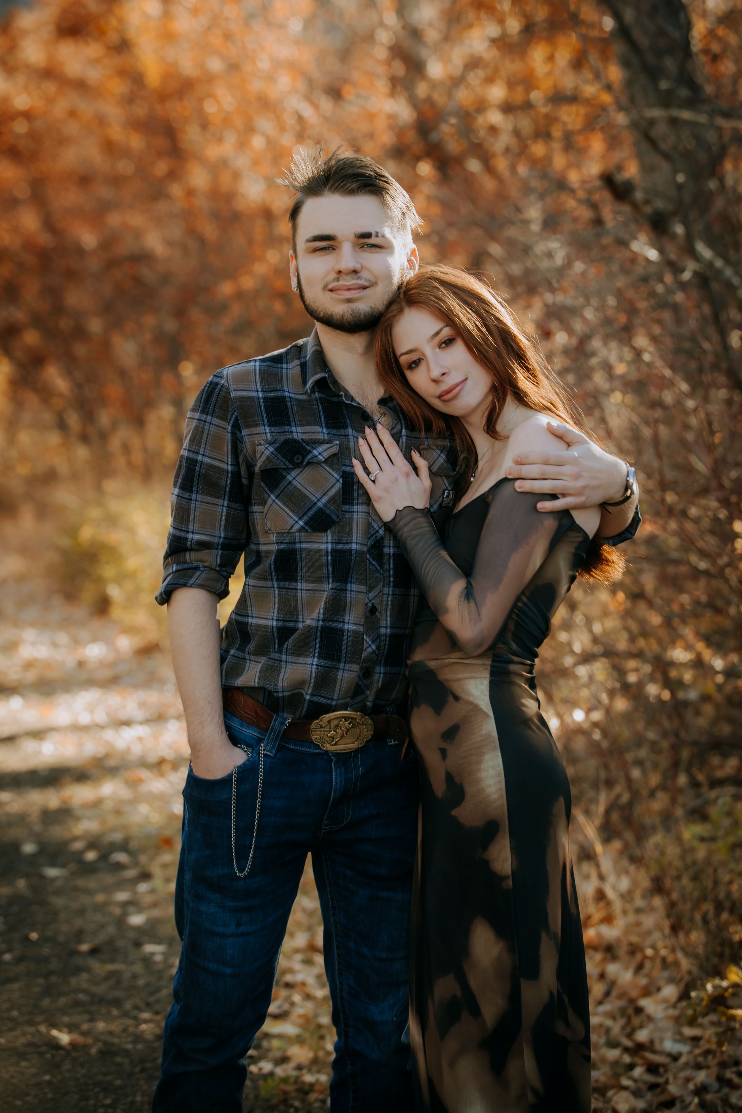 A couple embraces in an autumn setting with warm orange foliage and rustic styling in a series of connected photos.