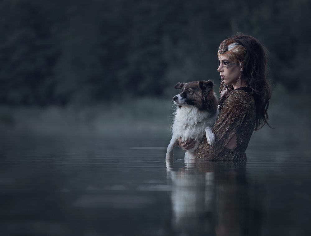 A figure emerges from misty water in a dramatic artistic photoshoot sequence.